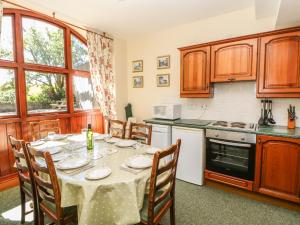 a kitchen with a table with a table cloth on it at Westfield Cottage in Mickleton