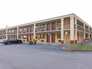 a building with a motorcycle parked in a parking lot at Days Inn by Wyndham Adairsville in Adairsville