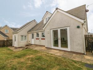 a house with a large sliding glass door at 5 Cae Derwydd in Cemaes Bay