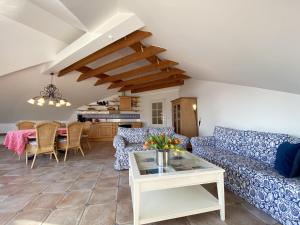 a living room with blue couches and a table at Villa Caprivi - Ferienwohnung 12 in Heringsdorf