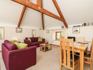 a living room with a table and a couch at Hartland View in Great Torrington