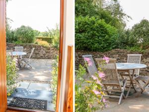 a patio with chairs and a table in a garden at Hartland View in Great Torrington