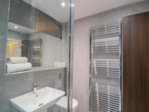 a bathroom with a sink and a toilet and a shower at Whitby Harbour Retreat in Whitby +8 photos