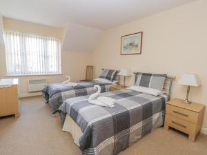two beds in a room with two swans on them at Whitby Harbour Retreat in Whitby