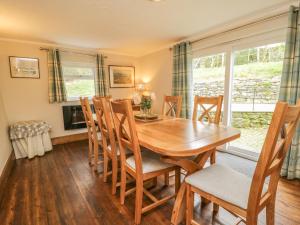 a dining room with a wooden table and chairs at Gill Head Farm in Mungrisdale