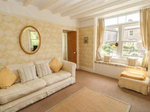 a living room with a couch and a window at The Homestead in Hawes