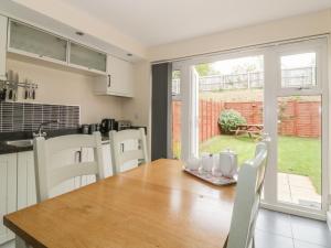 a kitchen and dining room with a table and chairs at Sandlings in Hollesley