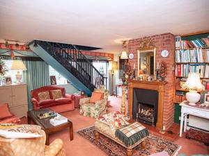 a living room with a fireplace and a staircase at Dorrington Court in Dorrington