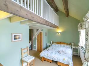 A bed or beds in a room at The Byre at High Watch
