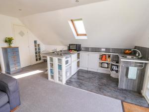 a large kitchen with white cabinets and a sink at The Stilehouse Apartment in Pensax +23 photos