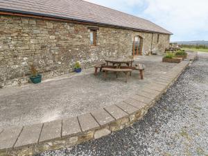 a picnic table in front of a brick building at The Stall in Llanmorlais