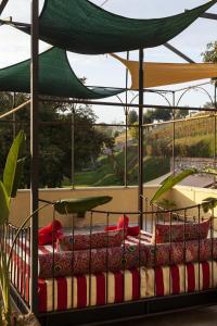 a bed with red and white pillows on it at Biondelli Boutique Winery in Cazzago San Martino