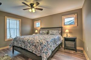 a bedroom with a bed and a ceiling fan at Finger Lakes 4-Season Getaway with Dock Access! in Conesus