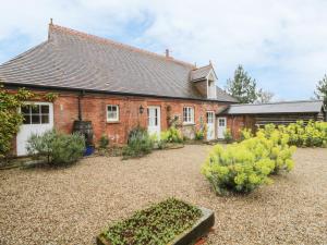 a brick house with a garden in front of it at Rookwoods in Sible Hedingham