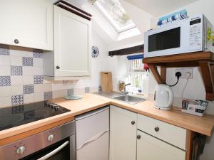 a kitchen with a sink and a microwave at Sunny Bank View in Bradwell