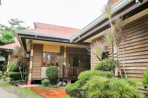 a wooden house with a porch and a balcony at OYO 435 La Veranda Beach Resort in Panglao