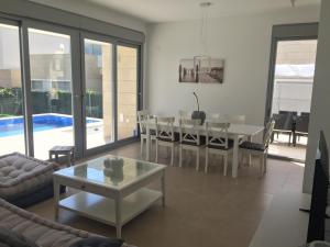 a living room with a table and a dining room at 3018 Vistabella- Malibu in Orihuela