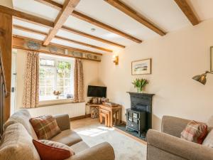 a living room with a couch and a fireplace at Old Town Cottage in Ludlow