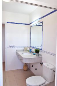 a bathroom with a sink and a toilet and a mirror at Siamoformentera Valentina in Sant Francesc Xavier