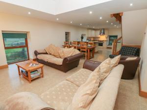 a living room with two couches and a table at Cambriol in Llangendeirne