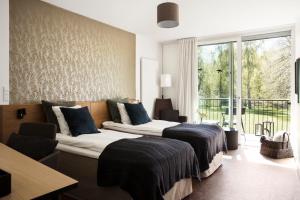 A bed or beds in a room at Rungstedgaard