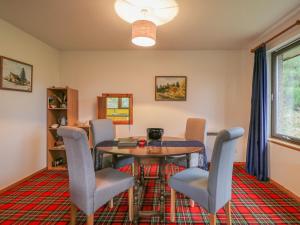 a dining room with a table and chairs at Tigh An Tearlach in Feshiebridge