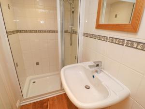 a white bathroom with a sink and a shower at The Annex - Eden House in Edenhall