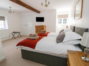a bedroom with a large bed and a television at Plas Yolyn in Ifton Heath