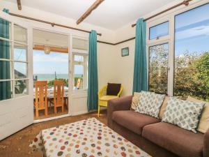 a living room with a couch and a table at Highdown in Bigbury on Sea