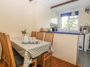 a kitchen with a table with a table cloth on it at Highdown in Bigbury on Sea +15 photos