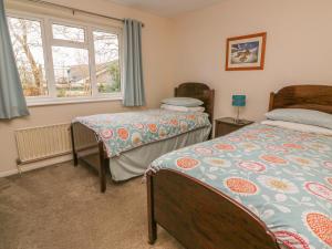 a bedroom with two beds and a window at Trederwen in Rhayader