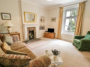 a living room with a couch and a fireplace at The Conifers in Hutton Magna