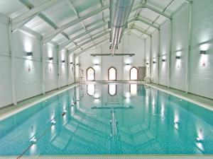 ReightonにあるWhite Rose Apartmentの建物内の青い水の大きなプール