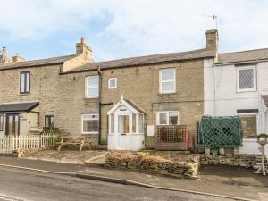 an old brick house with a white door at Dale View in Catton