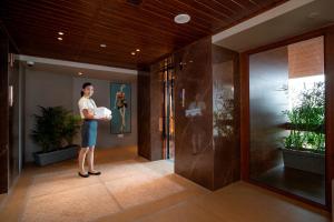 a woman standing in the hallway of a building at Yu Hotel, Candolim in Candolim