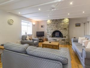 a living room with couches and a stone fireplace at Dale View in Catton