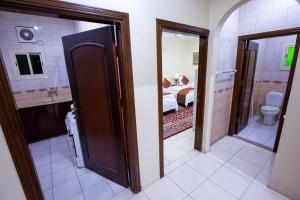a room with a bathroom with a bed and a toilet at Al Eairy Apartments - Makkah 8 in Mecca