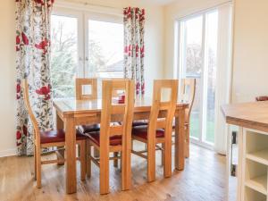 a dining room with a wooden table and chairs at Chaldon in Coldingham