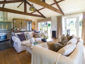 a living room with two couches and a table at Newton Retreat in North Charlton