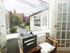a room with a window and a table with boxes at Number Fifteen in Withernsea