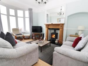 a living room with two couches and a fireplace at Number Fifteen in Withernsea