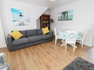 a living room with a couch and a table at Sunnie Cottage in Seahouses
