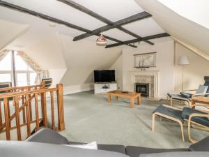 a living room with a tv and a fireplace at 4 Victoria Court in Sheringham