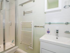 a bathroom with a shower and a sink at 5 Firle Road Annexe in Lancing +9 photos
