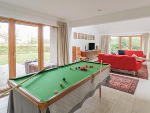 a living room with a pool table at Frater House in Alburgh