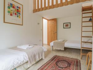 a bedroom with a bed and a ladder and a rug at Frater House in Alburgh