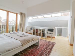a bedroom with a large bed and a television at Frater House in Alburgh