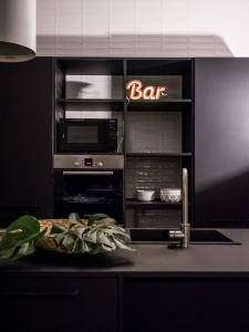 a kitchen with a bar sign on a counter at Le Logge in Parma