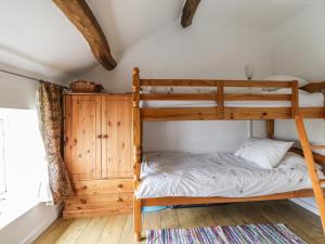 Uldale的住宿－Barn Roost，一间卧室设有双层床和窗户。