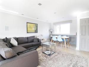 a living room with a couch and a table at Upper Oaks in Windermere